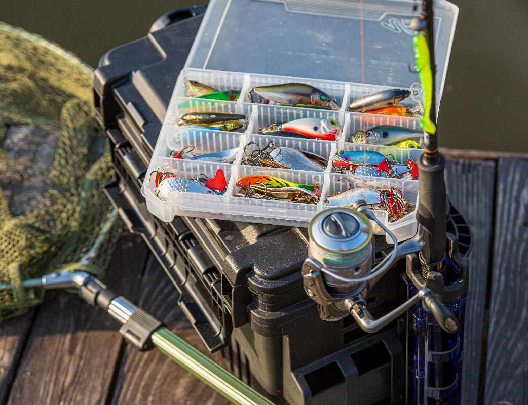 A,Large,Fisherman’s,Tackle,Box,Fully,Stocked,With,Lures,And A large fisherman's tackle box fully stocked with lures and gear for fishing.fishing lures and accessories. fishing spinning. Kit of fishing lures.